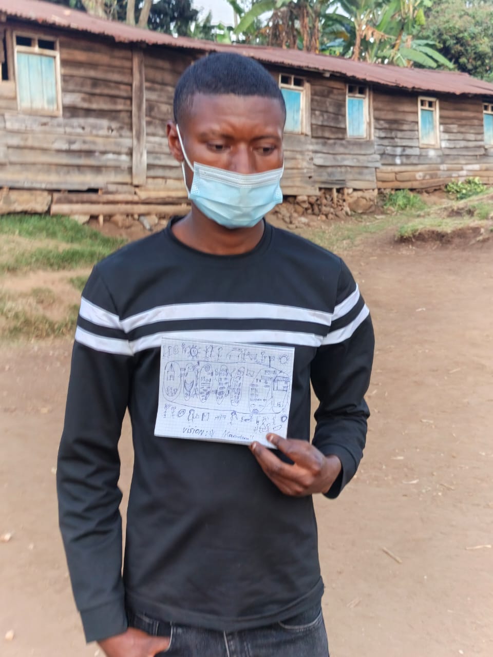 A Gender Equity participant in Mbasha holding her completed learning diagram